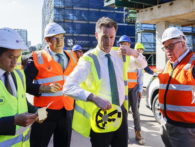 *POOL IMAGE* (L-)R New South Wales Minister for Better Regulation  Anoulack Chanthivong , Managing Director of Deicorp Fouad Deiri, New South Wales Premier Chris Minns and  New South Wales Building Commissioner David Chandler  arrive for a tour of the Deicorp Building Site in Sydney, Tuesday, May 16, 2023. Picture: AAP Image/Jenny Evans/NCA Newswire