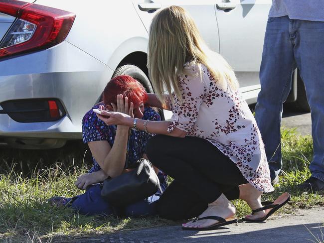 A woman consoles another as parents wait for news following the shooting. Picture: AP Photo/Joel Auerbach