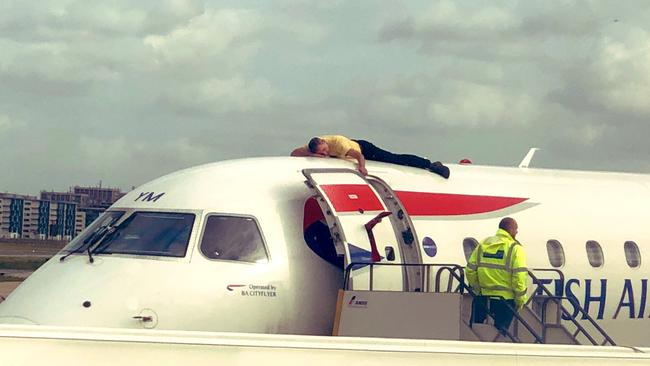 Paralympian James Brown lying on top of a British Airways plane during an Extinction Rebellion protest at City Airport, London Picture: Jonmew/Twitter