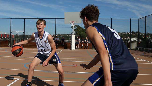 Kai Hush, 14, left, and Max Tumminello, 15, shoot some hoops at St Luke’s Grammar on Sydney’s northern beaches. Picture: Jane Dempster