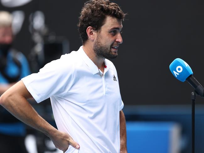 MELBOURNE, AUSTRALIA - FEBRUARY 16: Aslan Karatsev of Russia is interviewed after winning his Men's Singles Quarterfinals match against Grigor Dimitrov of Bulgaria during day nine of the 2021 Australian Open at Melbourne Park on February 16, 2021 in Melbourne, Australia. (Photo by Matt King/Getty Images)