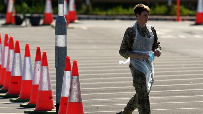 A defence serviceman prior to testing an essential worker for COVID-19 at a drive-in testing facility at Manchester Airport on Friday. Picture: AFP