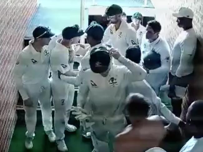 A supplied screen-grab obtained Monday, March 05, 2018 from a video of members from the Australian cricket side restraining David Warner as the team breaks for tea on day four of the first Test against South Africa. Warner can be seen in CCTV vision wanting to get close to South Africa's batsman Quintin de Kock as the teams walked upstairs to the change rooms during Sunday's tea break. (NO ARCHIVING IMAGE BEYOND 48 HOURS) (AAP IMAGE/Supplied/IOL) NO ARCHIVING, EDITORIAL USE ONLY