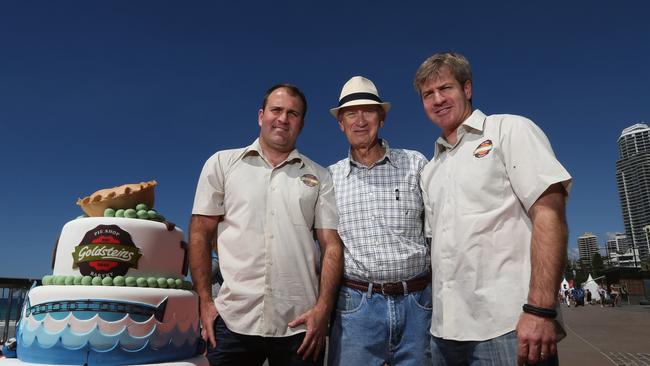 Frank Goldstein (centre) flanked by sons Martin Goldstein (left) and Joshua Goldstein (right) with a special cake made for the 70th year celebration of the business.