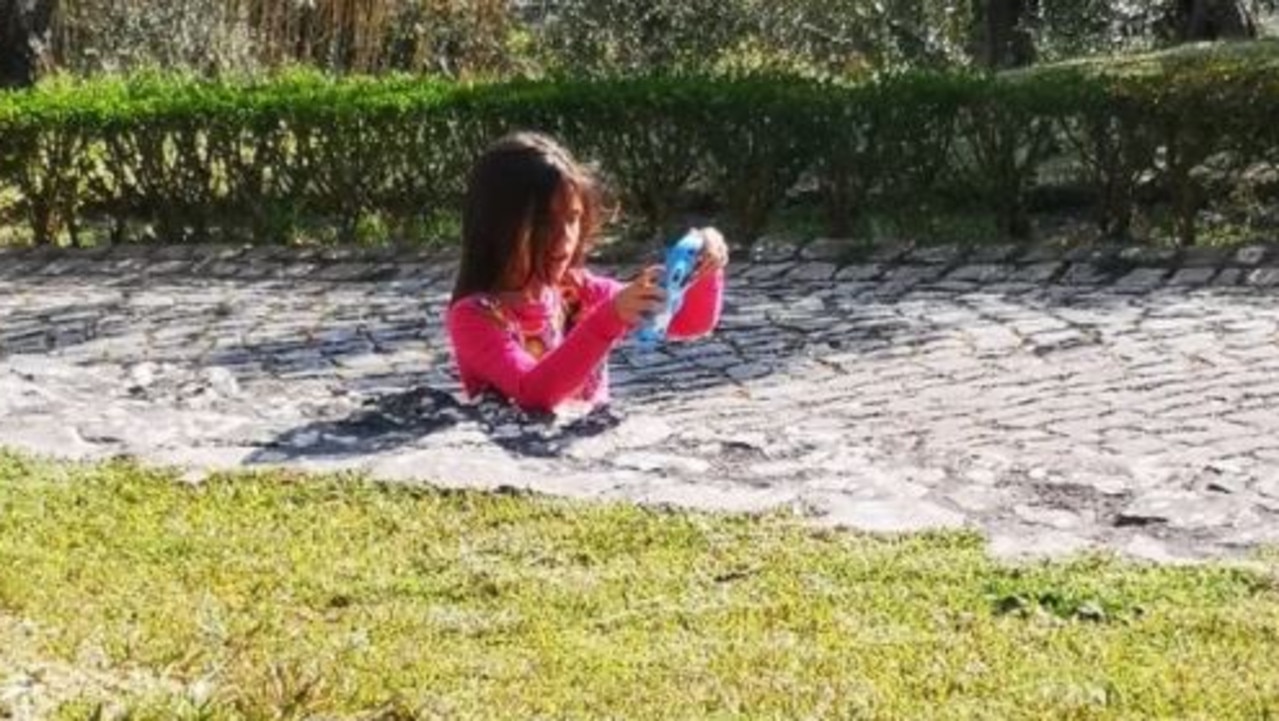 The internet is baffled over this photo of a girl seemingly stuck in the path. Picture: MK24ever/Reddit