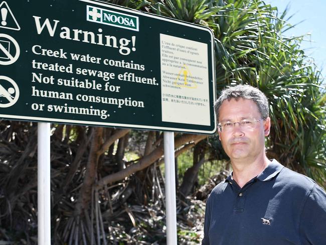 Noosa resident Pat Rogers next to one of the warning signs. Picture: Patrick Woods.