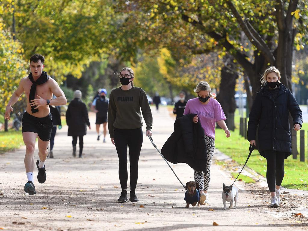 People exercise in Melbourne on Tuesday, the fifth day of the lockdown. Picture: William West