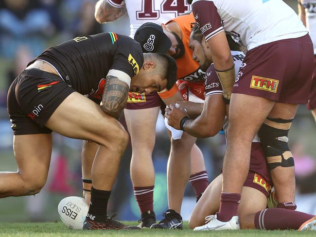 Martin Taupau of the Sea Eagles is attended to by a trainer after a tackle from Matt Burton. Picture: Matt Blyth/Getty Images