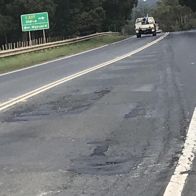 Traffic passes potholes on the Bass Highway near Wynyard