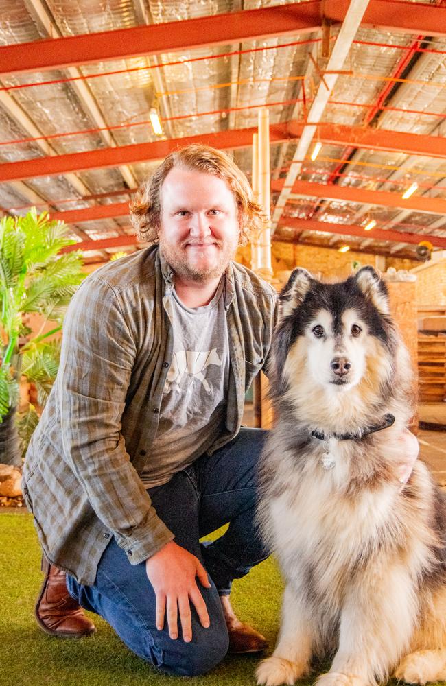 Josh Woodhouse, co-owner of doggy care day venue Wolfhouse, in Brisbane, pictured with team dog Anuk.