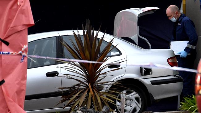 Forensic police look over the deceased man's car. Picture: Nicole Garmston