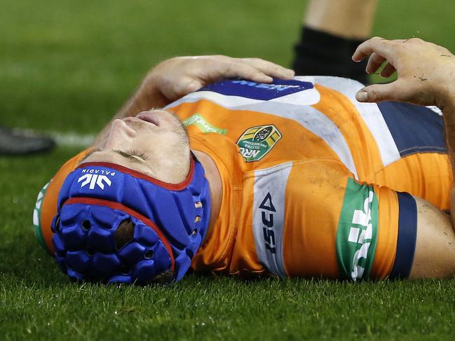 Jamie Buhrer of the Knights is treated by medical staff after injuring his knee during the Round 14 NRL match between the Newcastle Knights and the Sydney Roosters at McDonald Jones Stadium in Newcastle, Saturday, June 9, 2018. (AAP Image/Darren Pateman) NO ARCHIVING, EDITORIAL USE ONLY