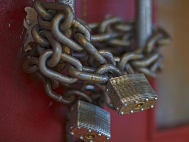 chain and locks on doors of closed business in downtown Chinatown closeup