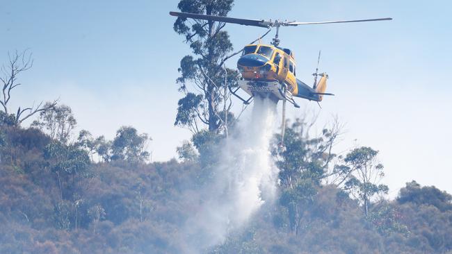 Helicopter dumping water. Bushfire in Dynnyrne threatening homes in 2022. Picture: Nikki Davis-Jones