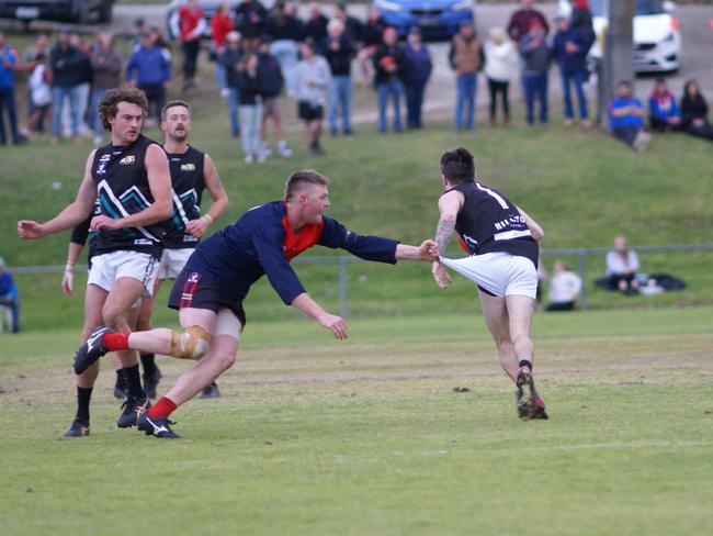 Omeo-Benambra's Jacob Tomkins slips a tackle from Swifts Creek’s Zac Tactor during the second semi-final at Swan Reach. Picture: Jason Darby