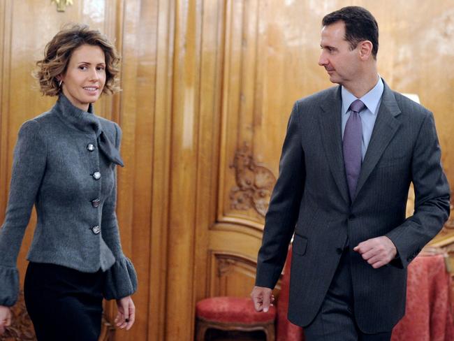 (FILES) Syrian president Bashar al-Assad and his wife Asma arrive to deliver a speech for the Syrian Community on December 9, 2010 in Paris during a two-day official visit to France. A Syria war monitor said that Assad has left the country, after losing swathes of territory to a lightning offensive led by an Islamist-led rebel coalition that said it entered Damascus on December 8, 2024. (Photo by Miguel MEDINA / AFP)