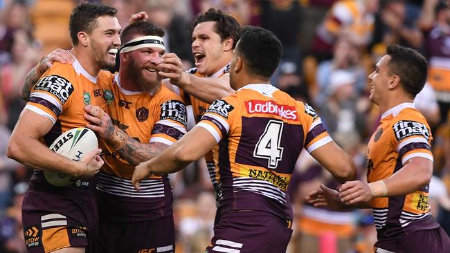 Corey Oates celebrates with his Broncos teammates after scoring a try. Picture: AAP