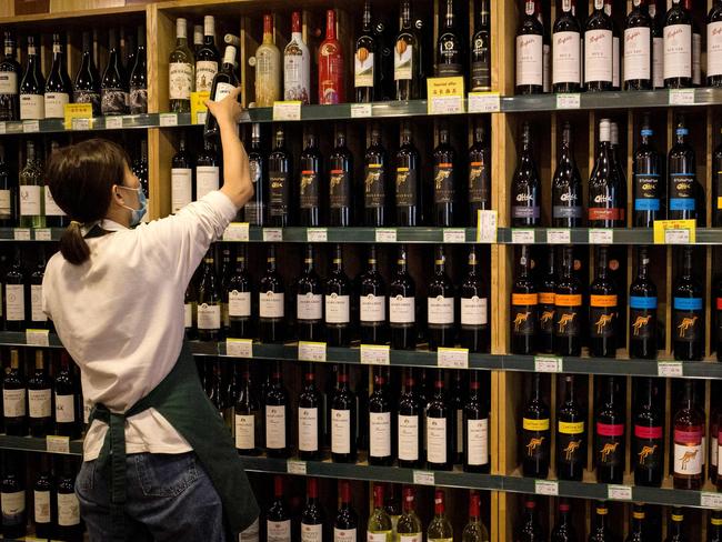 An employee in a store in Beijing. Picture: AFP