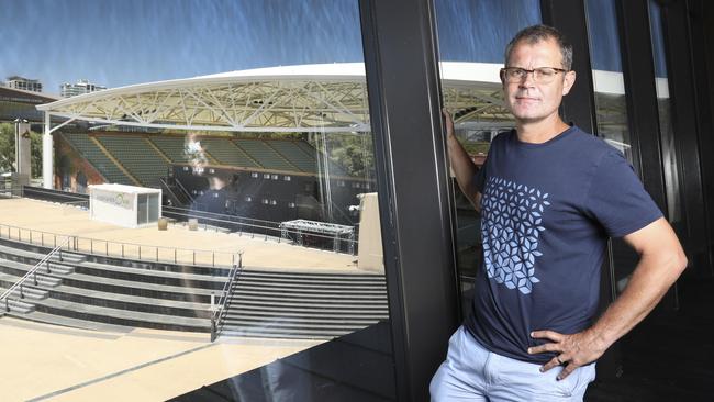 Adelaide International tournament director Alistair MacDonald standing in the Magarey Room at Adelaide Oval, with the newly-roofed Memorial Drive Tennis Centre in the background, in January. Picture: Dean Martin