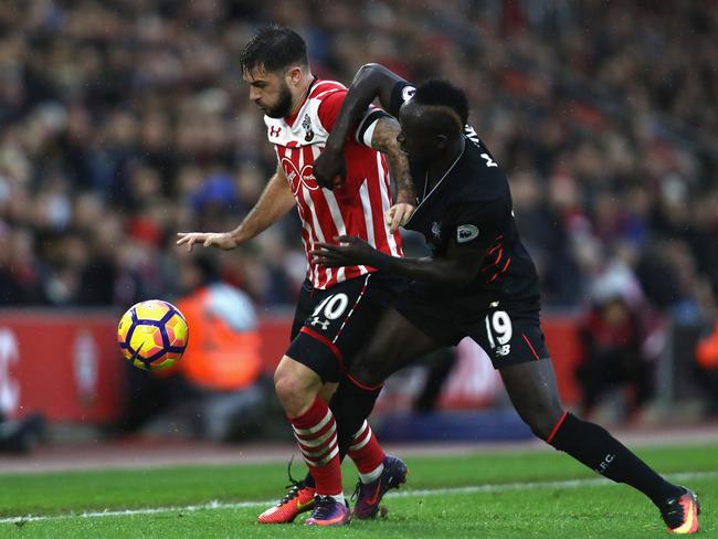 Charlie Austin of Southampton (L) and Sadio Mane of Liverpool (R).