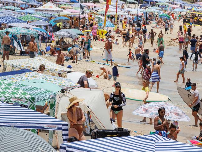 Crowds pack in to Noosa Main Beach on the New Years Day public holiday. Picture Lachie Millard