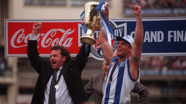 1996 Grand Final. North Melbourne v Sydney Swans. MCG. Coach Denis Pagan and captain Wayne Carey lift the premiership cup.