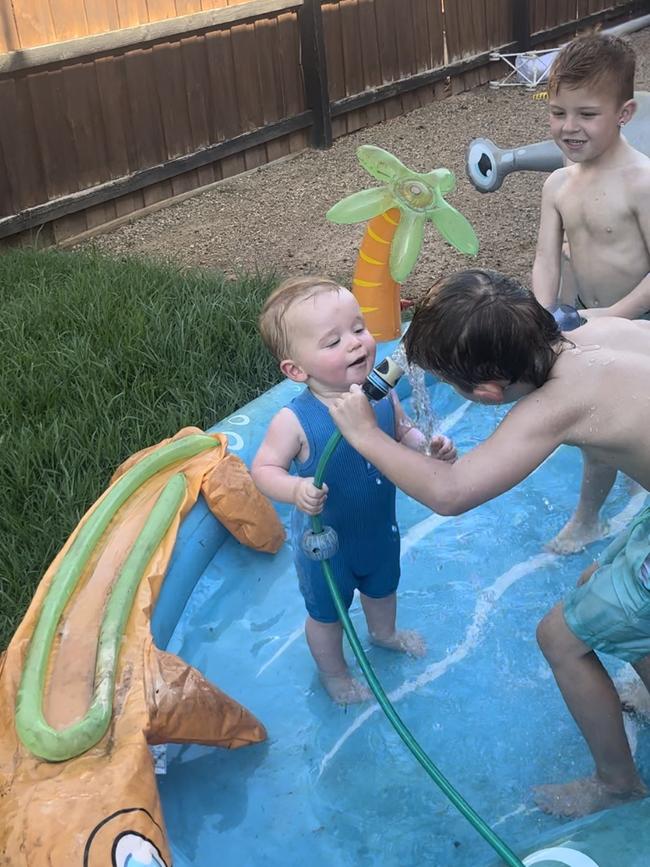 Ziggy taking charge of the garden hose at his Nana’s house in Brookfield, squirting his cousins Madden and Lennon. Picture: Tracey Disisto, Sunshine West.