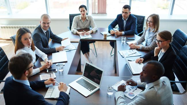 Businespeople at panel discussion in board room