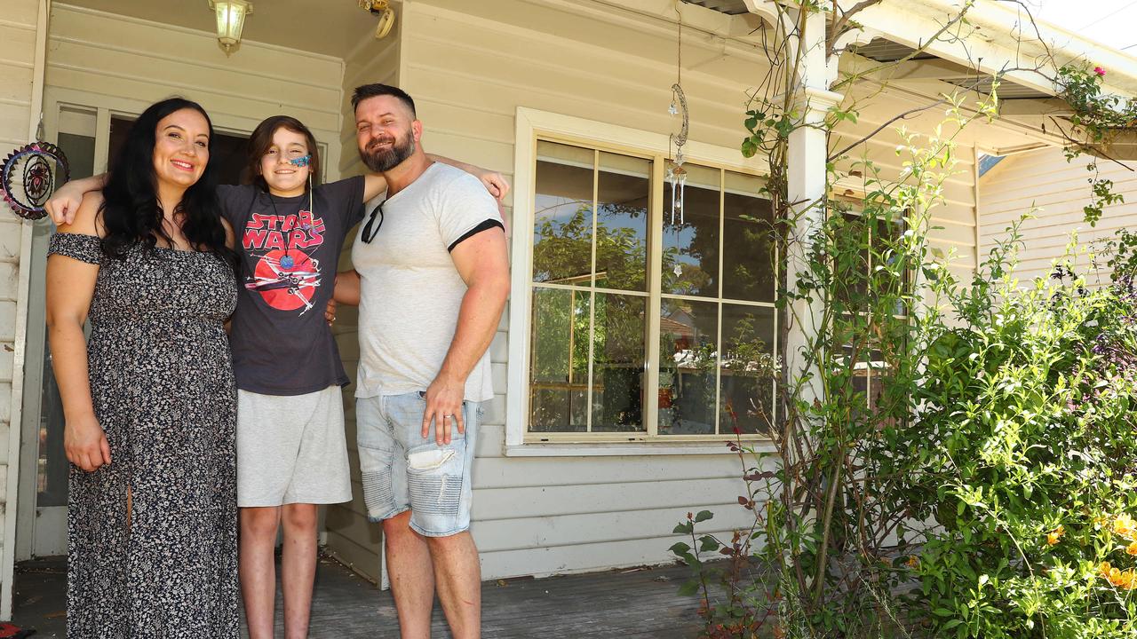 Seb Bridge with his parents Janelle and Daniel at their house which is currently being replastered. Picture: Alison Wynd