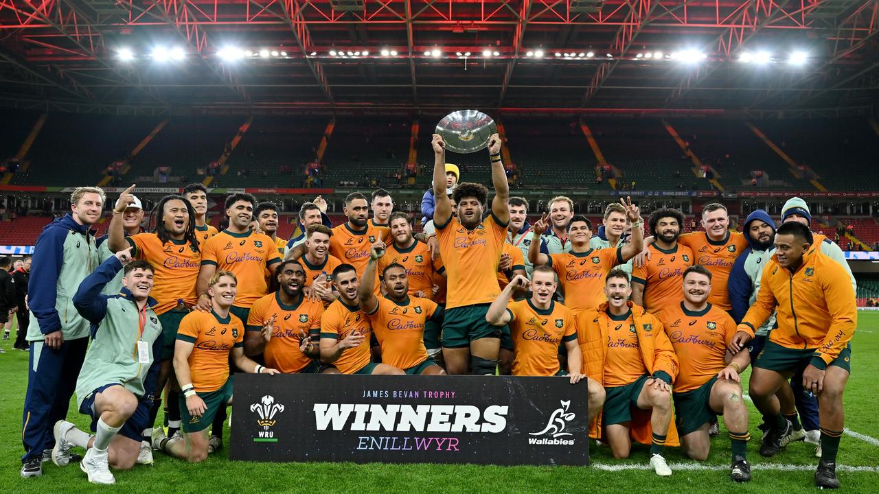 Rob Valetini of Australia lifts the James Bevan Trophy as players of Australia celebrate victory after defeating Wales. (Photo by Dan Mullan/Getty Images)