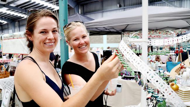 Jessica Monk and Ellen Hatton check out some earrings at Cairns Local Christmas Market at Cairns Showgrounds in December. Picture: Stewart McLean