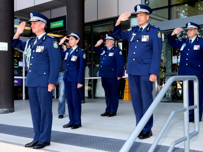 Andrew Scipione salutes and is saluted as he walked out of Bankstown Police station today. Picture: Adam Taylor