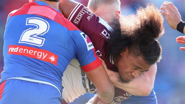 Moses Suli of the Manly Sea Eagles is tackled during the round 14 NRL match between the Newcastle Knights and the Manly Sea Eagles at McDonald Jones Stadium.