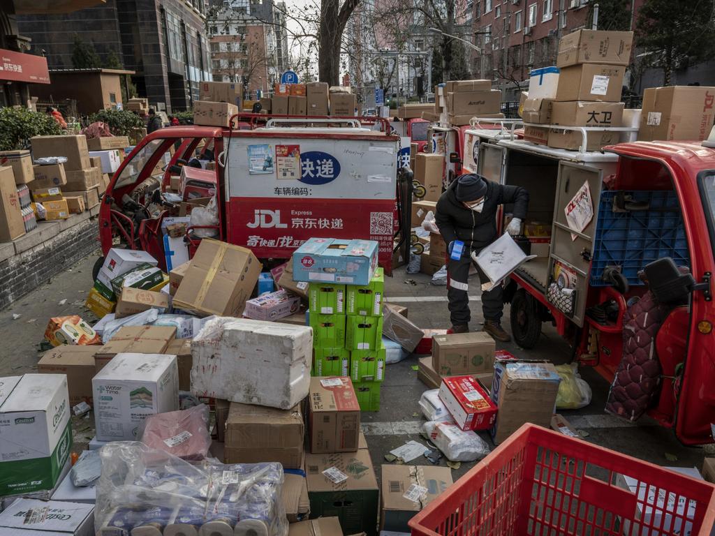 Economists are concerned the associated supply chain collapse could hit Australia, as Beijing promises it will release more accurate information. Picture: Kevin Frayer / Getty Images.