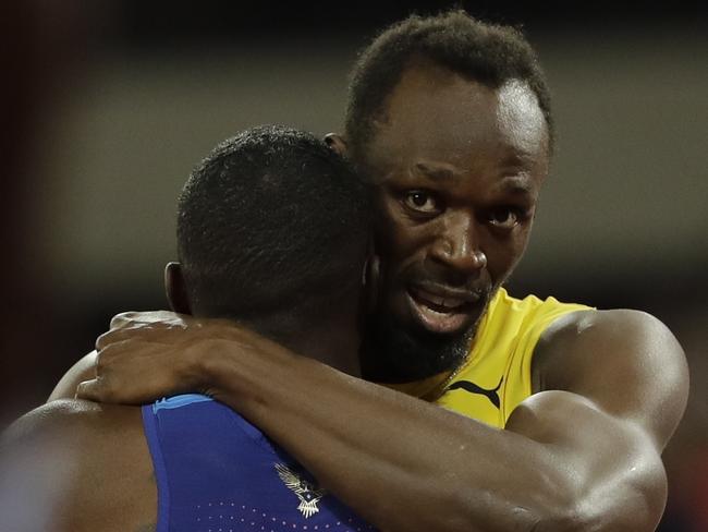 Jamaica's Usain Bolt, bronze, embraces gold medal winner United States' Justin Gatlin.