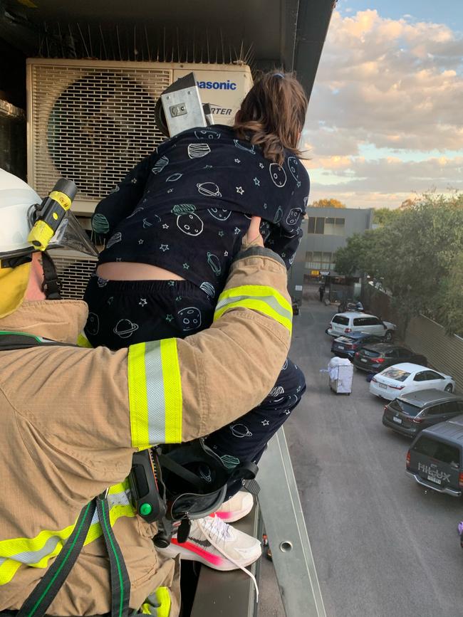 Hotel guest Darren Whitfield's daughter Isla, 11, is rescued from the hotel’s second floor by firefighters. Picture: Darren Whitfield