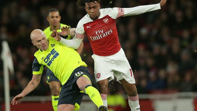 Arsenal's Nigerian striker Alex Iwobi (R) vies with Aaron Mooy (L) who injured his knee in the Premier League clash. (Photo by Daniel LEAL-OLIVAS / AFP) 