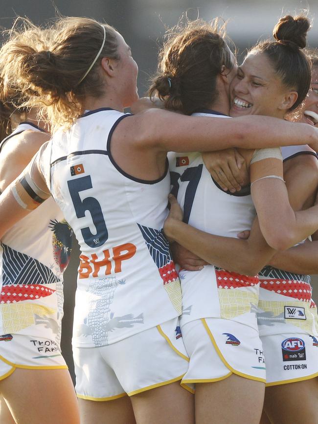 Crows players embrace after a goal during their crushing victory Picture: Daniel Pockett.