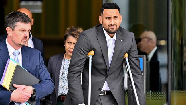 Nick Kyrgios (R) leaves the magistrate's court in Canberra.