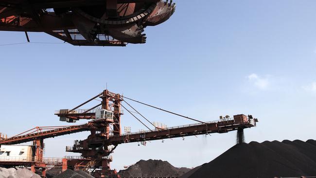 A conveyor belts dumps iron ore onto a pile at a transfer and storage centre in Shanghai. Iron-ore prices are surging again as steelmakers in China keep output high to support the economic recovery. Picture: Bloomberg