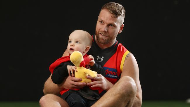 Jake Stringer with 2-year-old cancer patient Arthur James. Photo by Michael Klein.