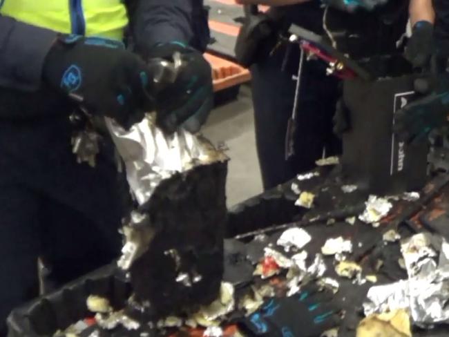 Officers uncovering the drug haul hidden in audio equipment bound for Melbourne. Source: AFP