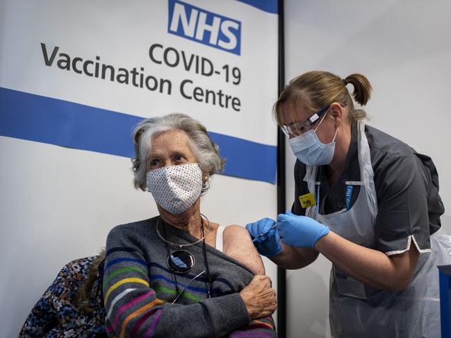 LONDON, ENGLAND - DECEMBER 08: Dr, Doreen Brown, 85, receives the first of two Pfizer/BioNTech Covid-19 vaccine jabs at Guy's Hospital at the start of the largest ever immunisation programme in the UK's history on December 8, 2020 in London, United Kingdom. More than 50 hospitals across England were designated as covid-19 vaccine hubs, the first stage of what will be a lengthy vaccination campaign. NHS staff, over-80s, and care home residents will be among the first to receive the Pfizer/BioNTech vaccine, which recently received emergency approval from the country's health authorities. (Photo by Victoria Jones - Pool / Getty Images) ***BESTPIX***