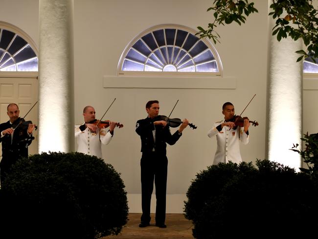 Violinists practice during a preview of the dinner. Mick Tsikas