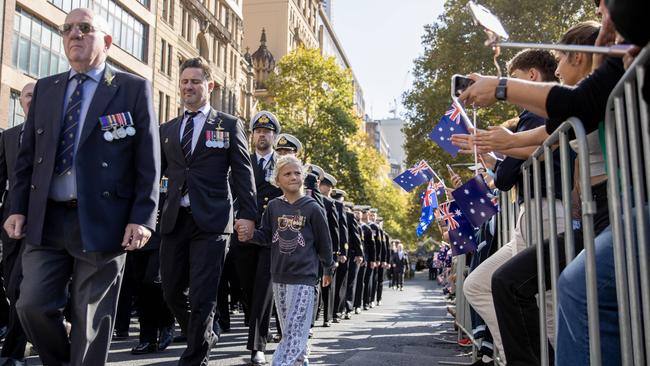 The crowd cheers as the parade moves down Elizabeth St. Picture: NCA NewsWire / Dylan Coker