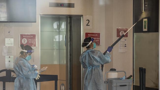 Cleaners wearing full PPE disinfect the Holiday Inn Hotel on February 10, 2021 in Melbourne, Australia. (Photo by Diego Fedele/Getty Images)