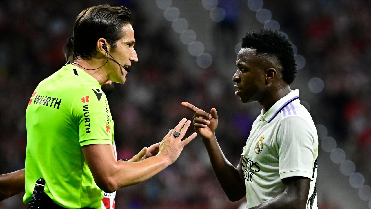 Real Madrid's Brazilian forward Vinicius Junior talks with referee Munuera Montero during the Spanish League football match between Club Atletico de Madrid and Real Madrid CF at the Wanda Metropolitano stadium in Madrid on September 18, 2022. (Photo by JAVIER SORIANO / AFP)