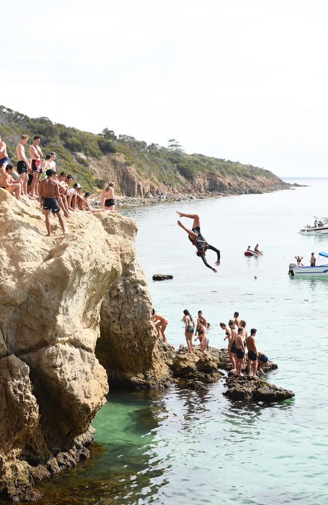 A diver jumps into the bay at The Pillars.