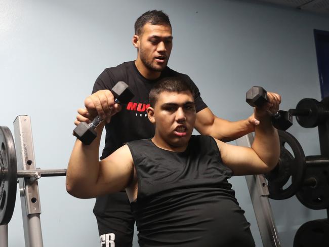 Tim Simona working as a personal trainer with Marwan Al-Hilali, who suffers from autism, at the Cabramatta Leagues Club gym. Picture: Brett Costello