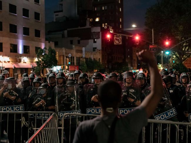 A man protesting police brutality stands on the Manhattan Bridge. Picture: AFP